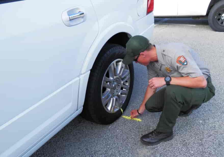 Mechanic With Orange Gloves Is Using Chalk To Mark Tires While Leaning On  One In His Workshop Stock Photo - Download Image Now - iStock